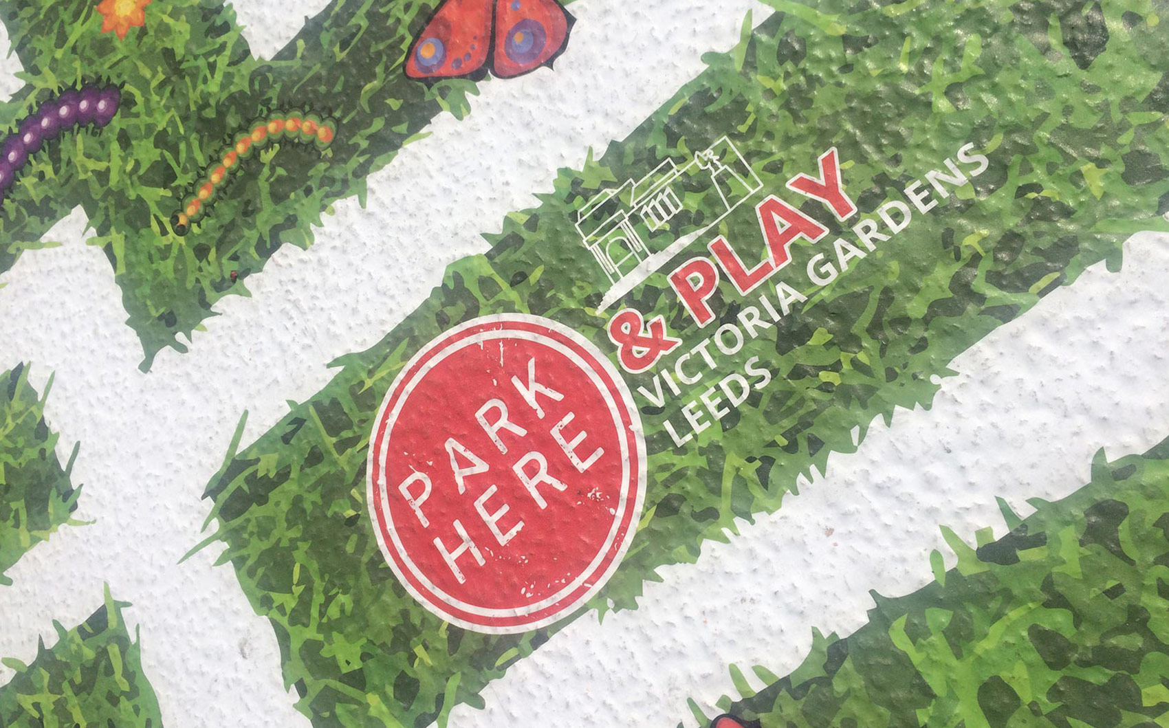 PARK HERE and Play logo road maze