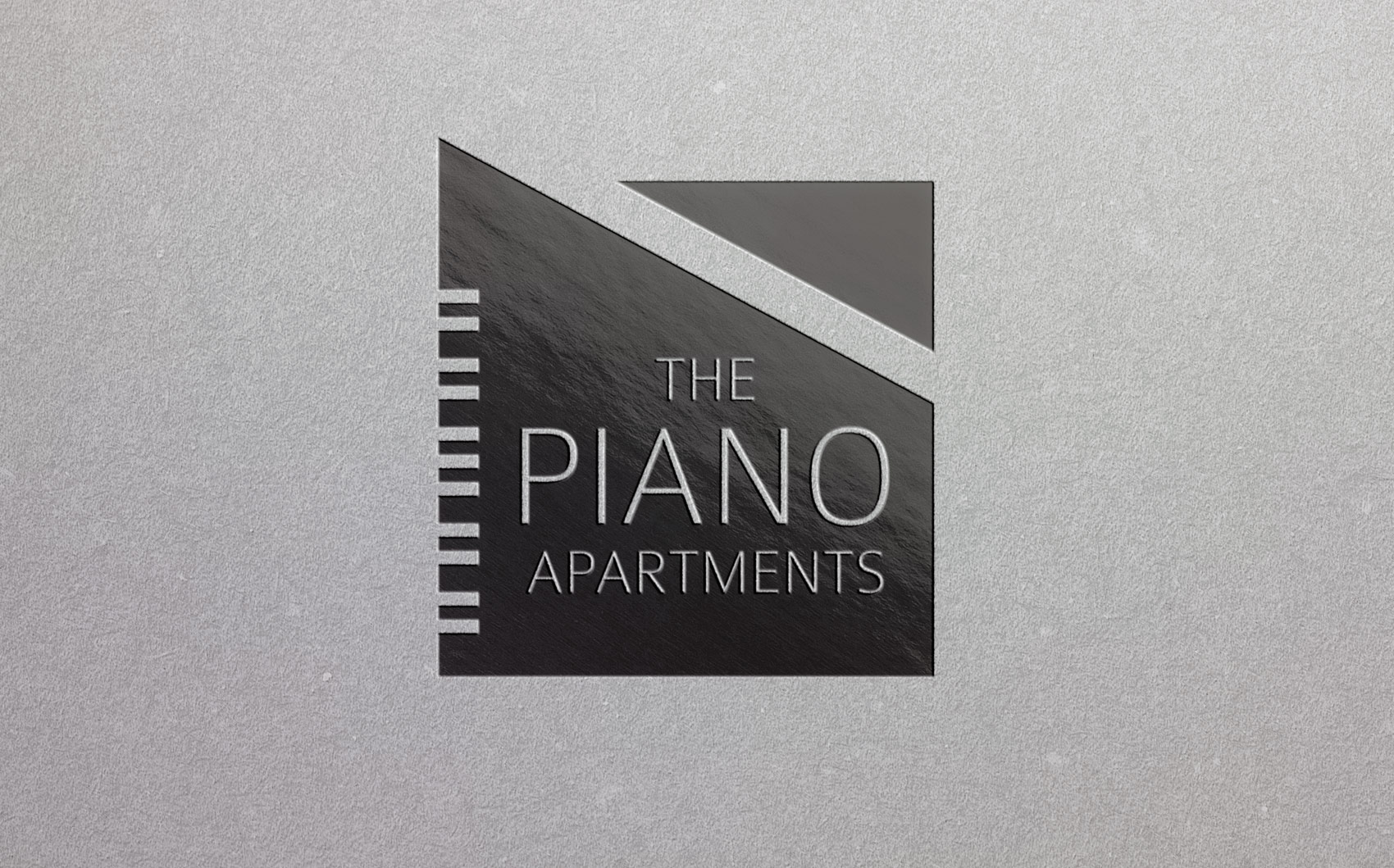 Piano Apartments, Clapham, London logo etched onto the wall