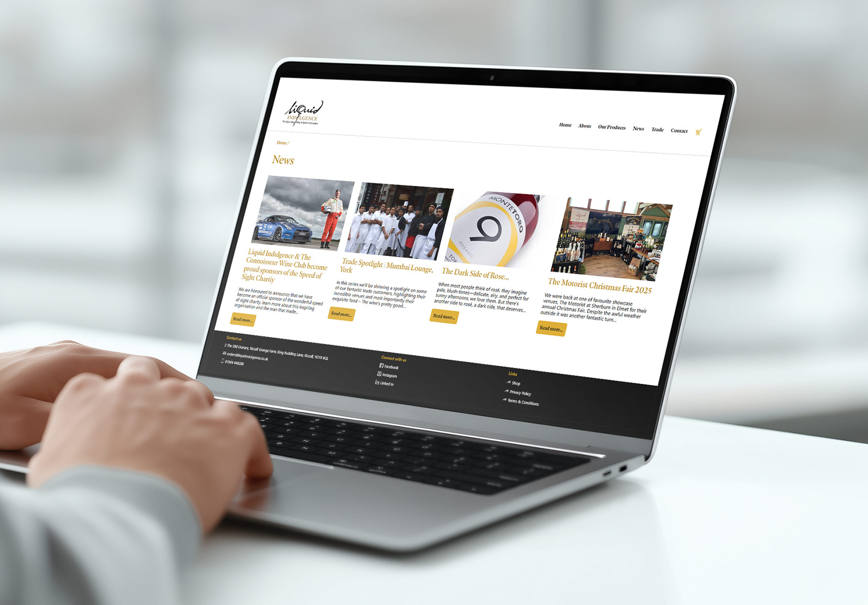 Liquid Indulgence website news page laptop